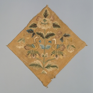 Fragment of Chinese embroidery showing two opposed birds. China, early 8th century.