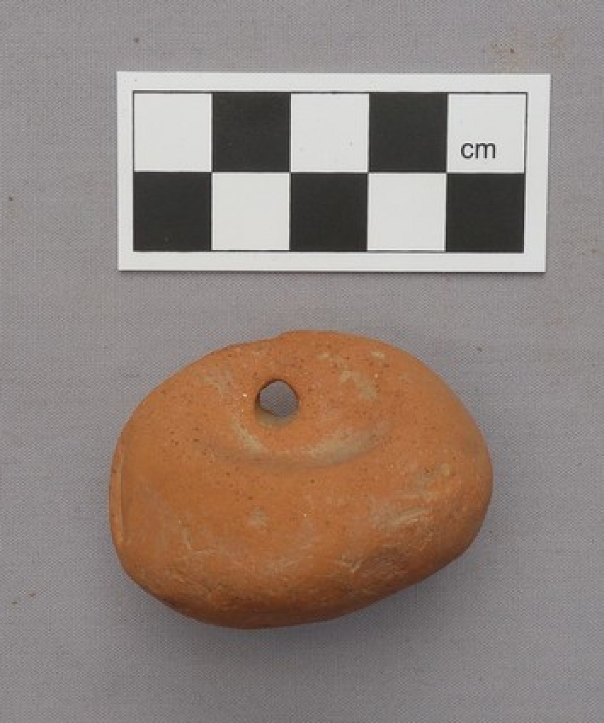 Ancient Greek loom weight, although the small size would suggest it to be something else.