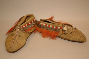 A pair of moccasins from the Northeast Indians (?) decorated with glass beads and moose hair tassels, 1860s.