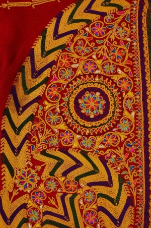 A detail from a woman’s jacket from Bethlehem showing the use of cord couching with embroidery to create stylised floral motifs with floss silk details (early 20th century).