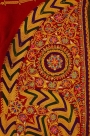 A detail from a woman&rsquo;s jacket from Bethlehem showing the use of cord couching with embroidery to create stylised floral motifs with floss silk details (early 20th century).