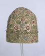 An early seventeenth century embroidered nightcap for a man. It is decorated with silk and metal thread embroidery and spangles.