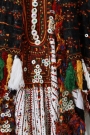 Detail of the embroidery on a black headdress and white wedding dress from the Siwa oasis, showing the traditional Siwa colours and the mother-of-pearl buttons, 1970&#039;s.