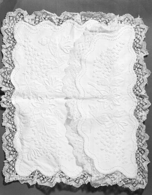 Cotton sachet with Mountmellick whitework and bobbin lace edging. Irish, c. 1880