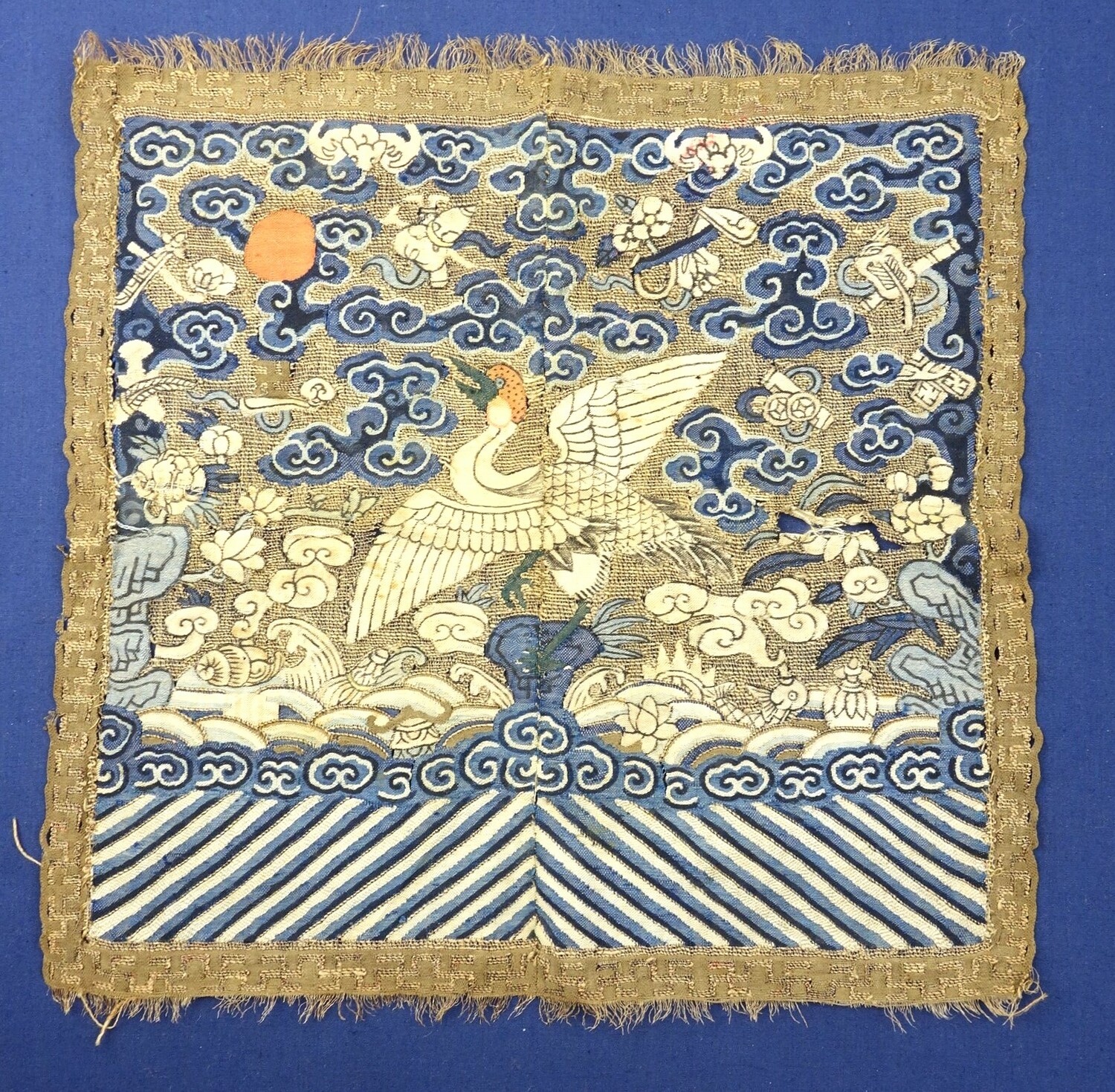 Fig. 1. A woven rank panel with the design of a bird (crane) facing towards a red sun. China, 19th century (TRC 2016.2363).