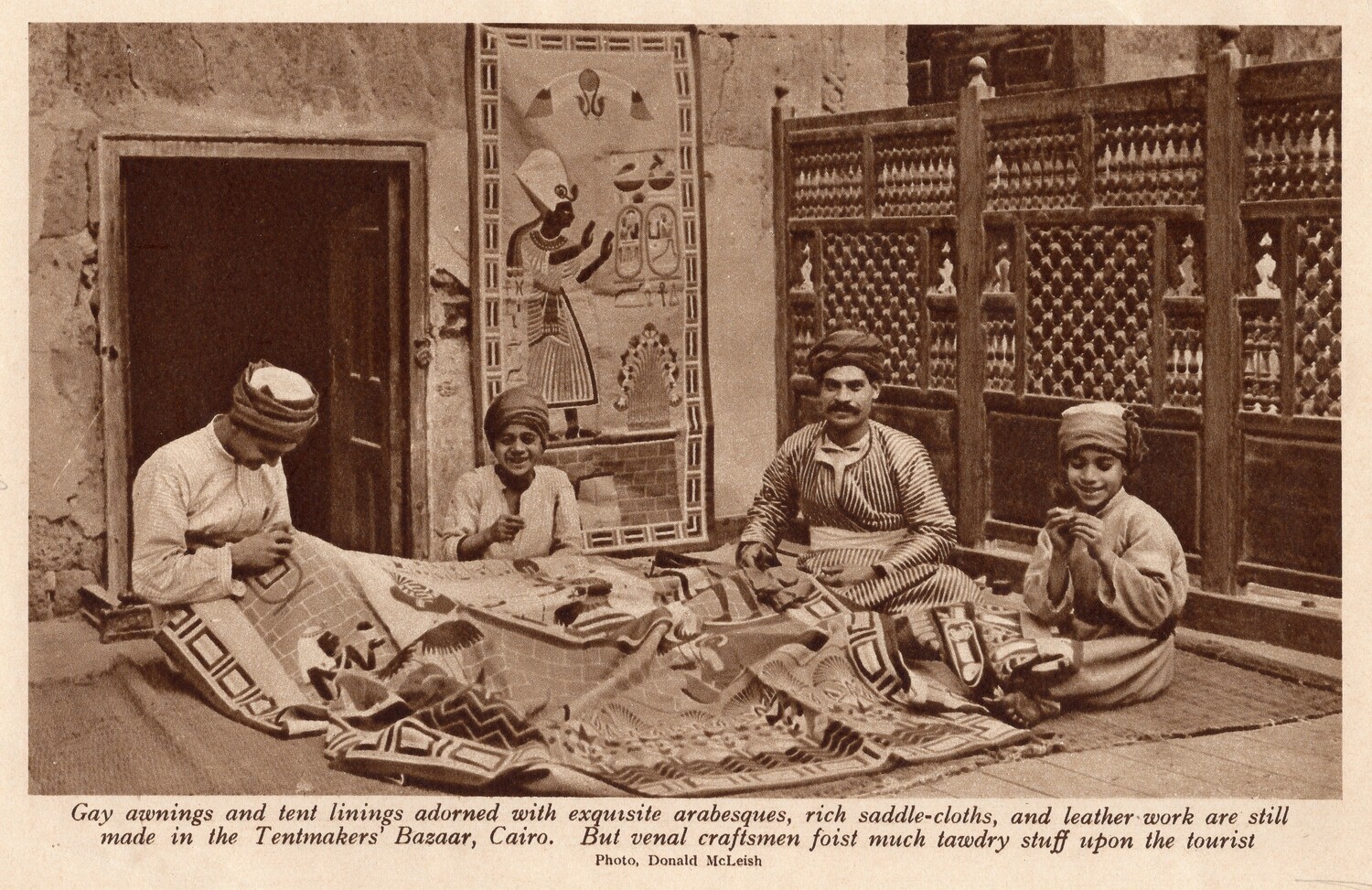 Magazine image, early 20th century, of a group of embroiderers in the Street of the Tentmakers, Cairo, Egypt, making appliqués for the tourist market (TRC 2017.2350).