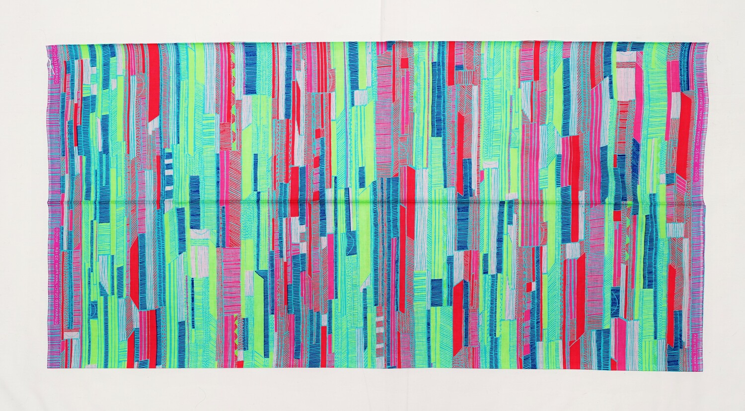 Length of cloth with an abstract design of lines and blocks in lime green, red, pink, dark blue and turquoise. There is a selvedge text that states: "GUARANTEED DUTCH JAVA PRINT 5216a. VLISCO". The Netherlands, 2022 (TRC 2022.2267).