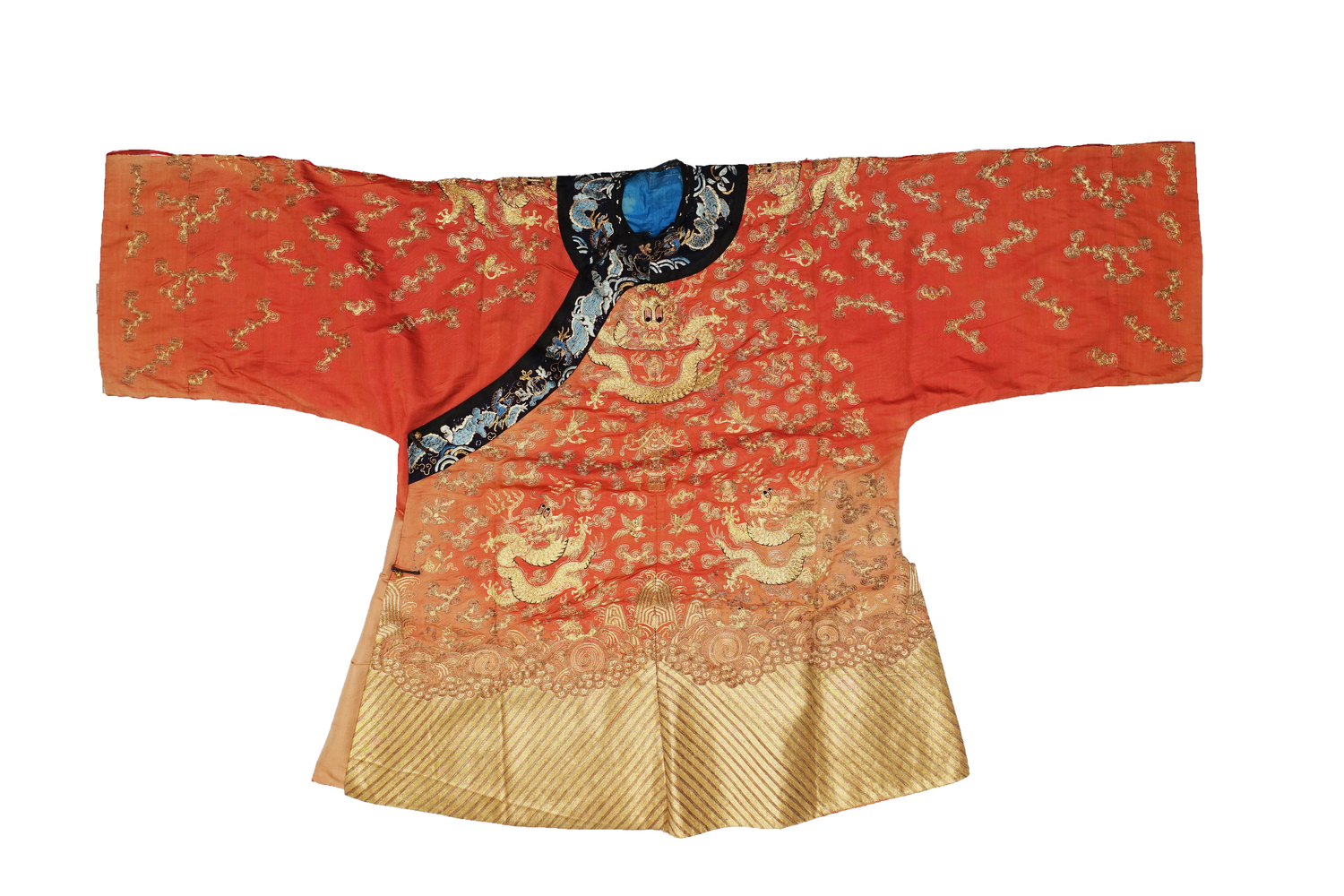 Fig. 7. Full length gown decorated with embroidered dragons, cloud motifs, bats, birds and flowers, in mainly gold coloured thread, and silk threads in various shades of blue. China, 20th century (TRC 2023.0934).