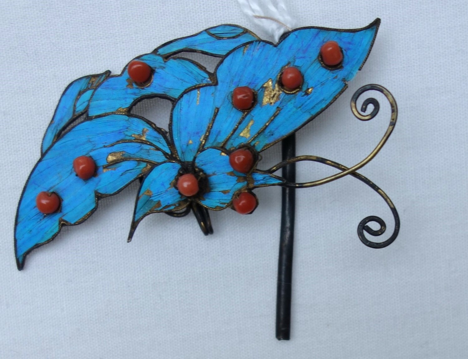 Hair pin in the shape of a butterfly, with kingfisher feather decoration (TRC 2023.2522).