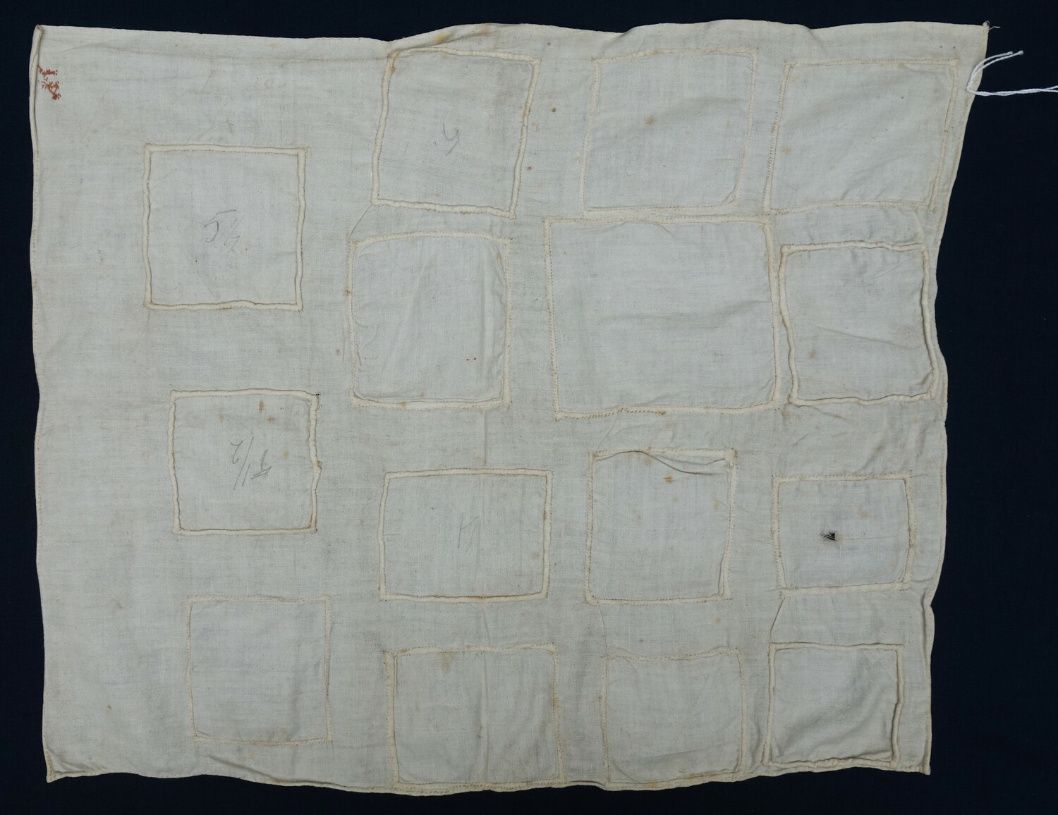 Fig. 3: School sample, not particularly well done, with fifteen examples of patching stitched with white thread. The Netherlands, early 20th century (TRC 2024.1671).
