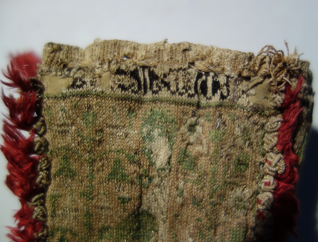 Close-up of part of the inscription at the top of Side 1 of the knitted bag (Sens Museum, B323, 13th century).