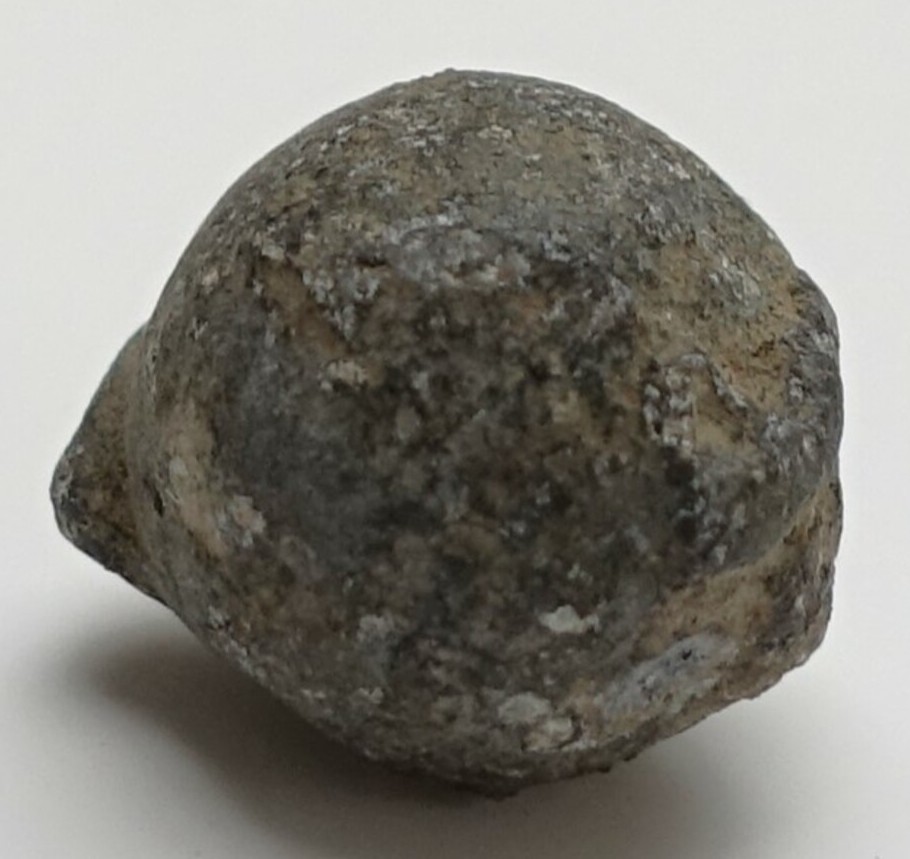 A cast spherical lead bullet or musket ball. 15th-18th century. TRC 2024.2770.