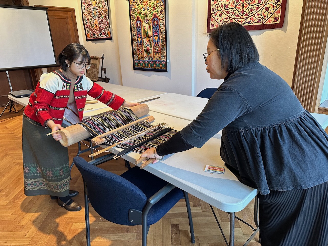 Yuma Taru and her daughter adjusting the backstrap loom that they donated to the TRC in 2013.