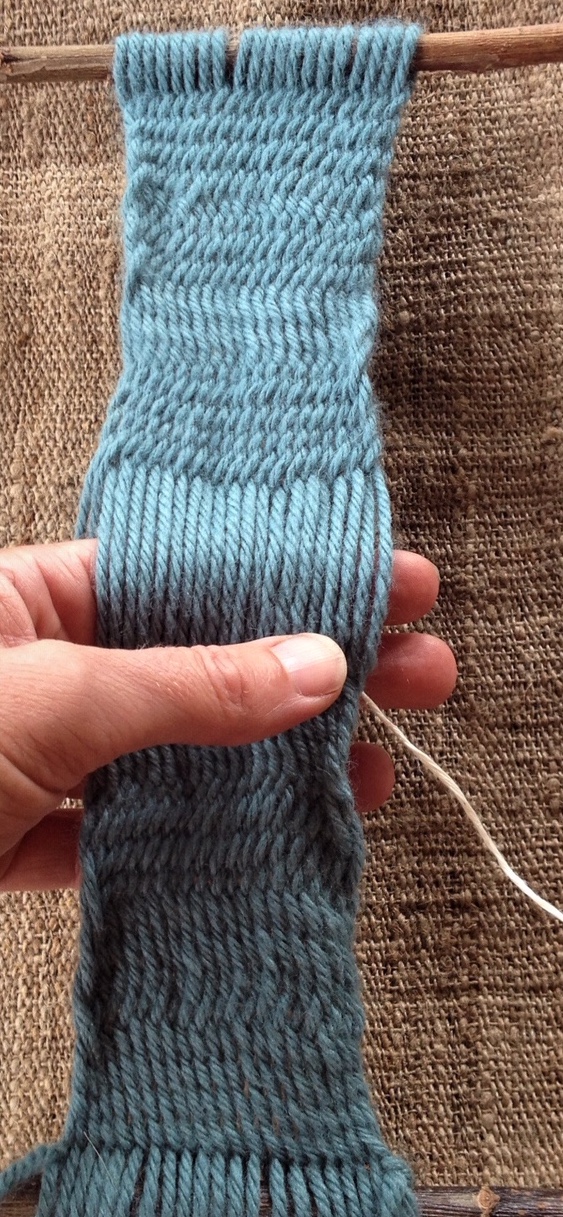 Braiding a band of sprang. Photograph: Dorothee Olthof.